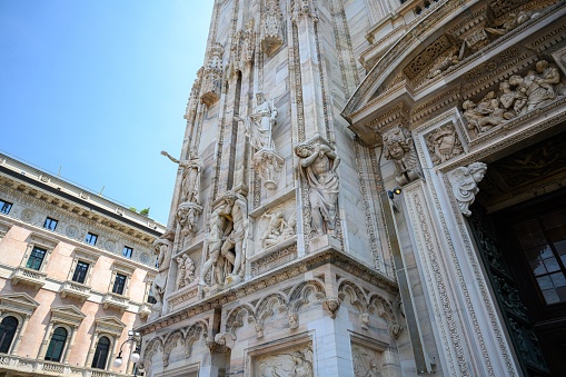 MIlan, Italy – June 18, 2023: Close-up of the Milan Cathedral corner with the beautiful summer day and blue sky.