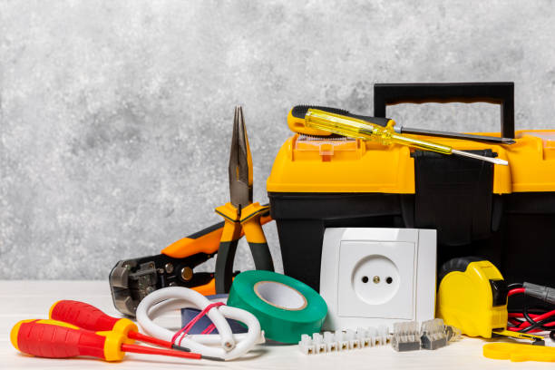 istock Electrician equipment on background with copy space.Top view.Electrician tool set.Multimeter, tester,screwdrivers,cutters,duct tape,lamps,tape measure and wires.Flet lay. 1720764398