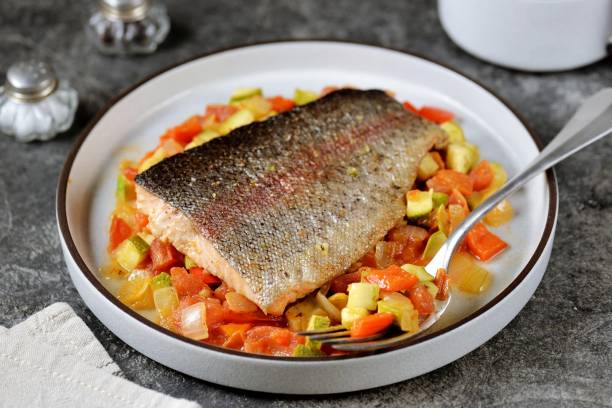 istock Wild trout stewed in white wine with vegetables 1720765553