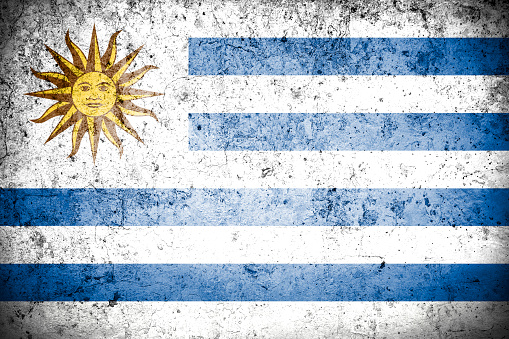 Flag of Uruguay with faded grunge effect, perfect for backgrounds and design.