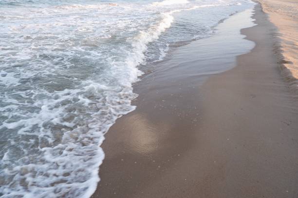 istock Clear sea water, wave and sand beach. Text space. 1720784883