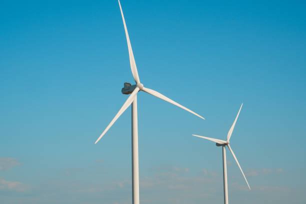 istock Wind turbines generating electricity with blue sky - renewable energy conservation concept. Wind turbines farm 1720785456