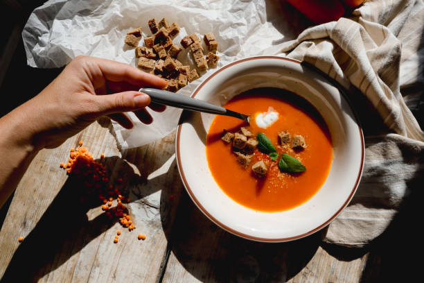 istock A hand with a spoon, pureed soup with crackers 1720800541