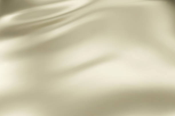 istock Close-up texture of natural cream silk. Light Gold fabric smooth texture surface background. Smooth elegant golden silk in Sepia toned. Texture, background, pattern, template. 1720810407