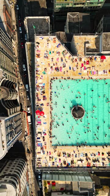Time-lapse of people in the pool on the terrace of a building in an urban center