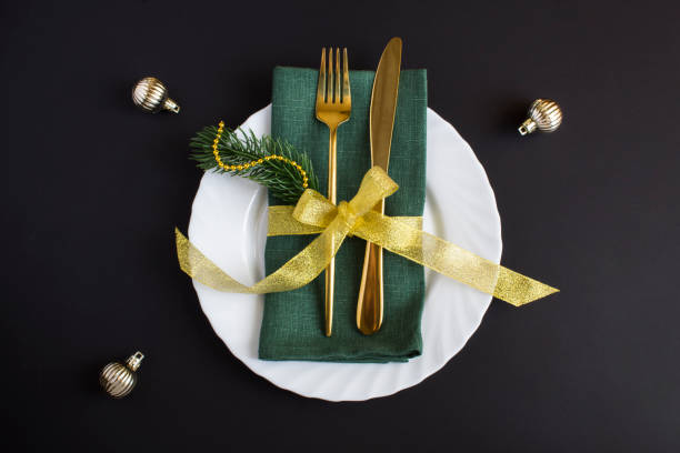 istock Christmas table setting with green napkin on the black background. Top view. Close-up. 1720832410