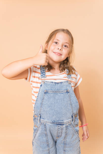 istock girl smiling with raised thumb 1720836269