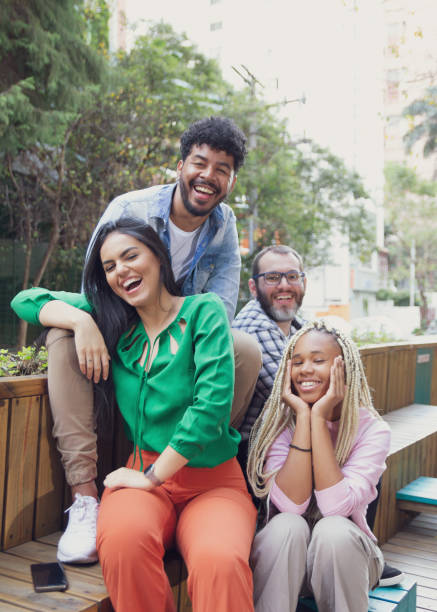 friends sitting on bench talking and laughing