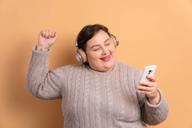 istock excited woman dancing with headphones 1720840735