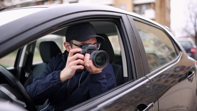 Private Detective Taking Photos At Stake-out