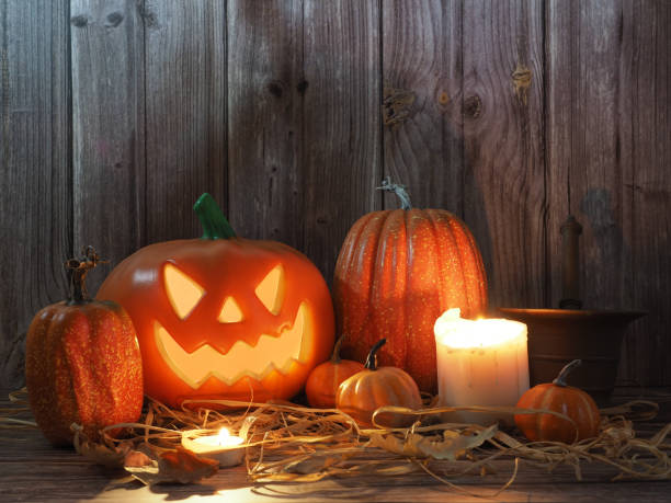 istock Halloween pumpkin head lantern on wooden background 1720852565