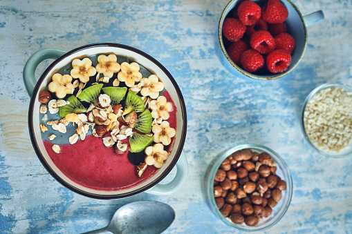 Pitaya Smoothie in Bowl with Kiwi, Banana, Blueberries and Superfoods on Top