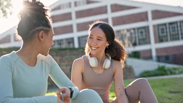 Fitness, outdoor and girl friends in conversation while relaxing after a health workout. Gen z, smile and happy young women talking, bonding and resting together after sports training or exercise.