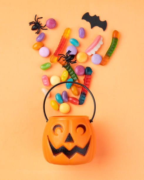 istock Assorted colorful candies over orange background. 1720914482