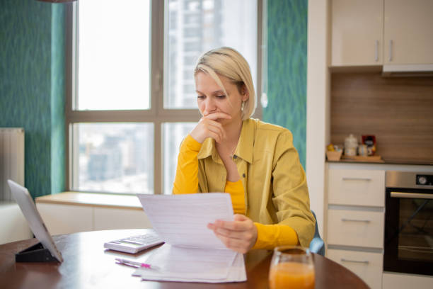 istock Young woman is going through bills and finances 1720943054