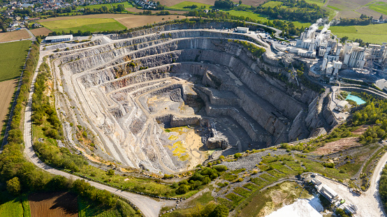 Aerial view of a large limestone quarry and industrial buildings