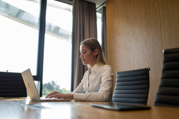istock Business woman working on laptop in modern office 1720979332