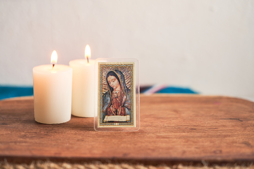 Virgen de guadalupe with candles, religious image of mexico.