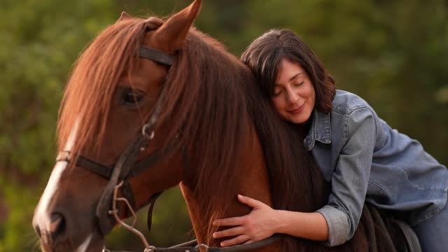 Young woman embracing her horse on a rural scene