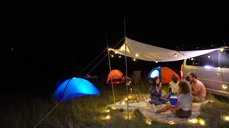 Friends camping together at night