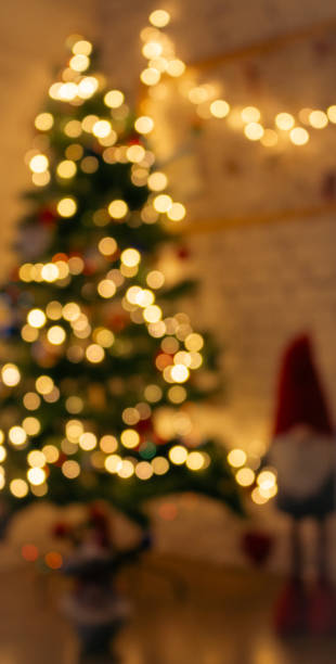 istock Golden Christmas lights on dark background, unfocused. Illuminated bokeh background. Glowing lights, defocused. Winter holidays magic. Golden stardust lights. Christmas decoration. 1721067539