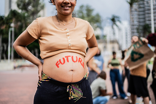 Pregnant woman during protest outdoors