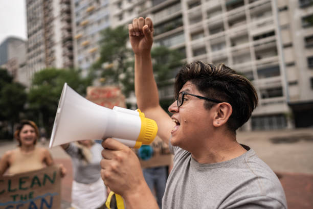Mature man talking in a megaphone during protest outdoors