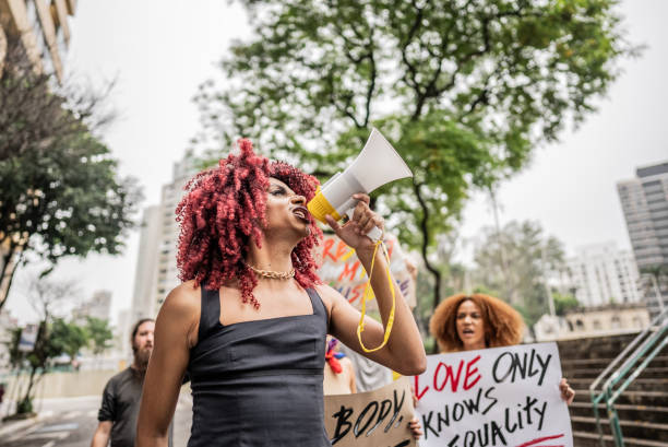 istock Person talking in a megaphone during a protest in the street 1721100384
