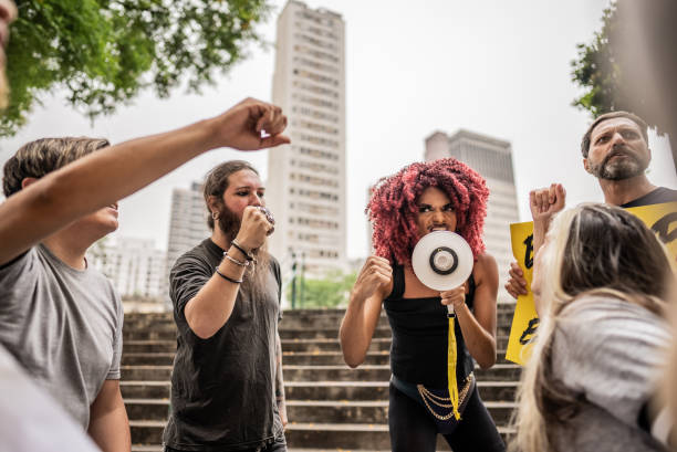 Person talking in a megaphone during a protest in the street