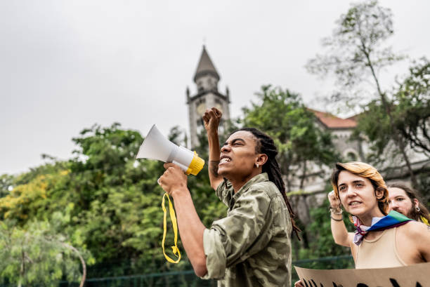 istock Young man talking in a megaphone during a protest in the street 1721100913