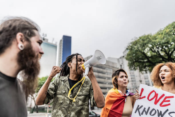 istock Young man talking in a megaphone during a protest in the street 1721103188