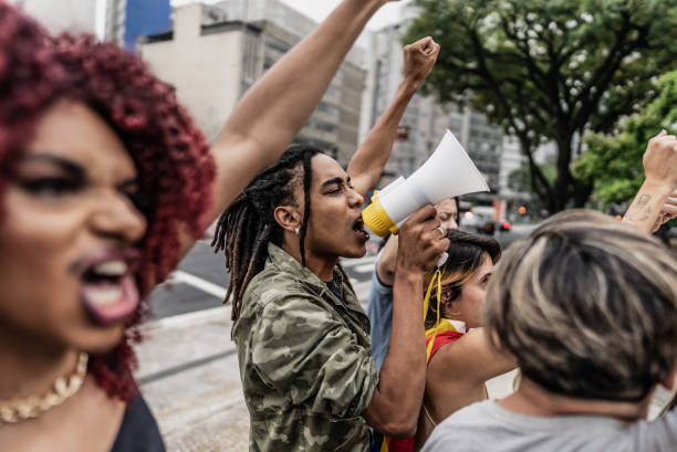 istock Young man talking in a megaphone during a protest in the street 1721103215