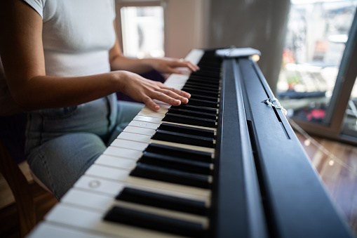 Close-up of a woman playing synthesizer