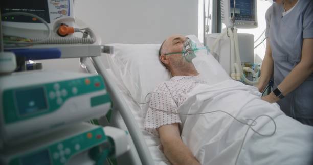 istock Friendly nurse adjusts life support machine for old patient 1721114953