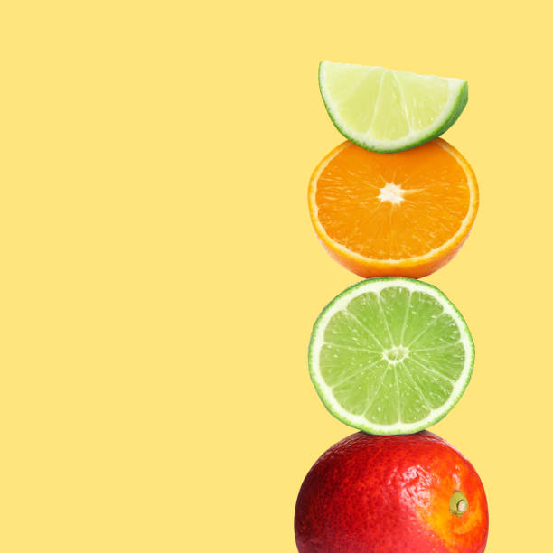 istock Stack of different fresh citrus fruits on light yellow background, space for text 1721116582
