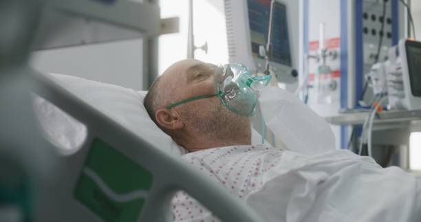 istock Elderly man in oxygen mask lies in bed during artificial lung ventilation 1721120422