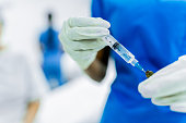 Close-up of a female nurse preparing vaccine at the hospital