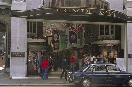 London, England, UK, 1976. The entrance to the Burlington Arcade. Furthermore: pedestrians and shops.
