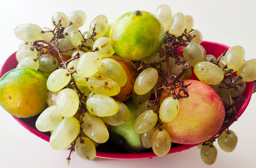 Grapes, apples and tangerines in fruit bowl