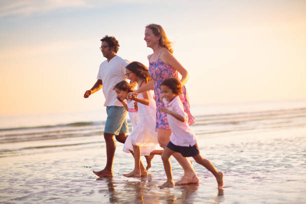 istock Family walking on tropical beach at sunset 1721174728