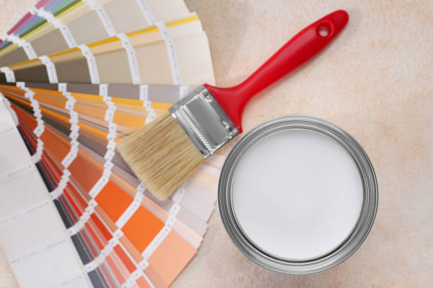 istock Can of white paint, brush and palette on beige table, flat lay 1721175861
