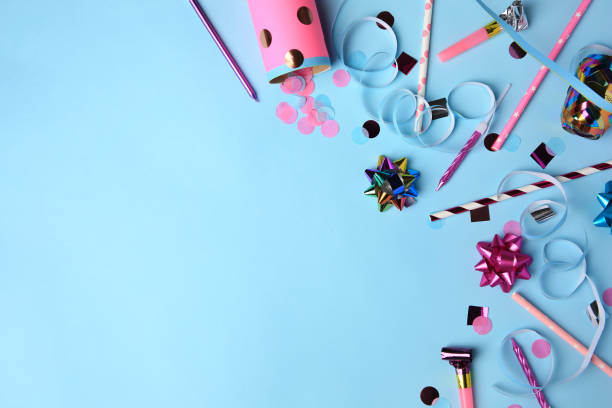 istock Party popper with confetti, blower and festive decor on light blue background, flat lay. Space for text 1721175870