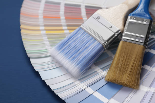 istock Paint brushes and palette on blue wooden table, closeup 1721176955