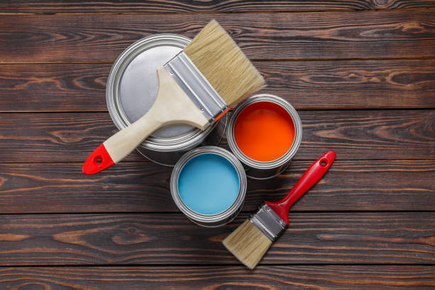 istock Cans of light blue and red paints with brushes on wooden table, flat lay 1721177271
