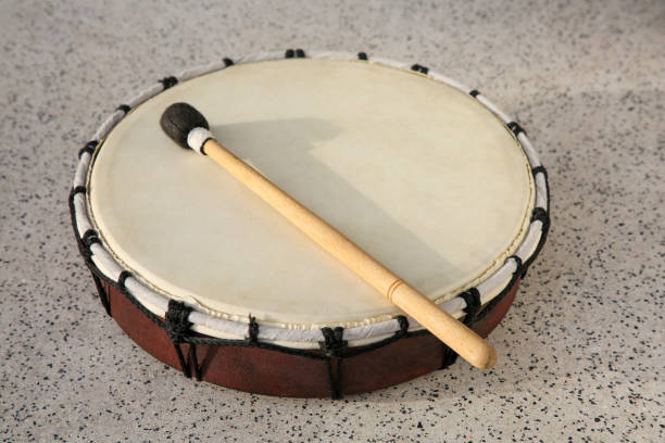 istock Drum and drumstick on grey table, closeup. Percussion musical instrument 1721188306