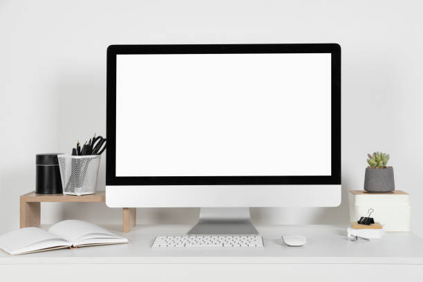 istock Cozy workspace with computer, houseplant and stationery on white desk at home 1721188863