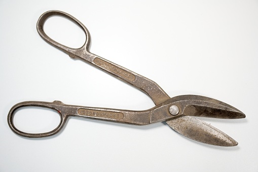 Close-up of letter scale with blue ribbon on white background.