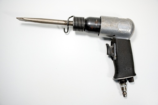 Automatic handgun and bullets in a plastic hard case on white background