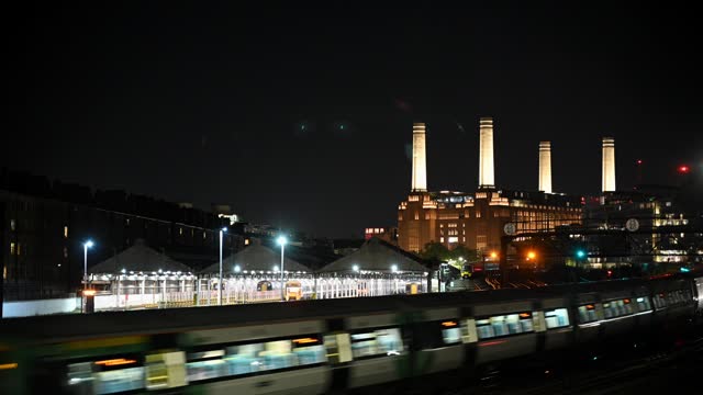 Night view of Battersea Power Station and train depot in London