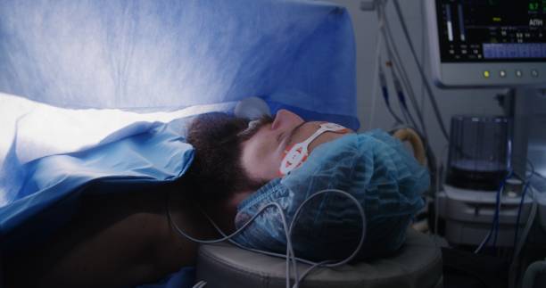 istock Close up of male patient lying on table under anesthesia 1721209239